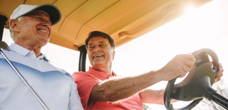 Two Men Driving a Golf Cart